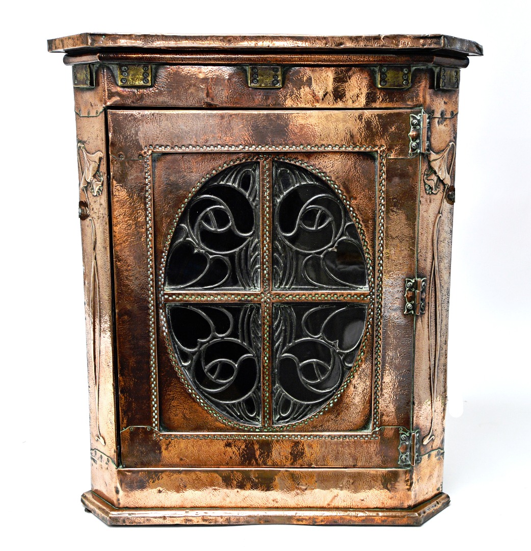 Appraisal: A Liberty's retailed copper and brass veneered hanging corner cupboard