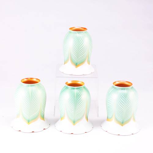 Appraisal: QUEZAL Four art glass shades with green and gold feather