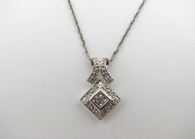 Appraisal: K White Gold pendant with four princess cut diamonds on