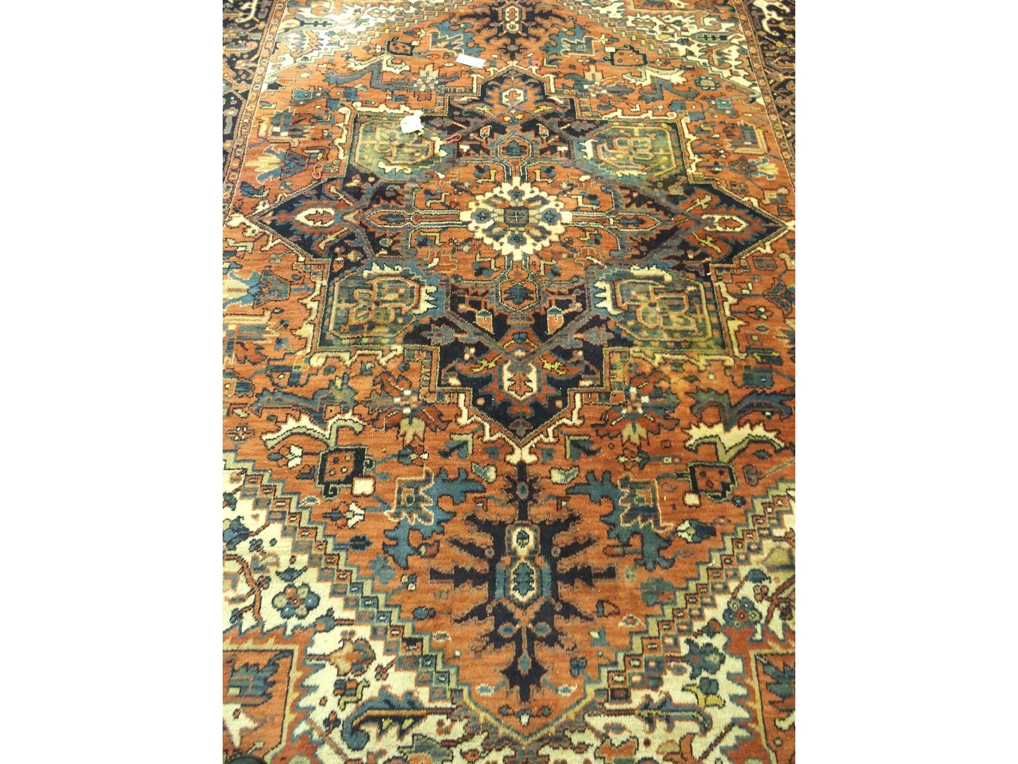 Appraisal: A Kadjar carpetwith central geometric floral medallion on a multi-coloured