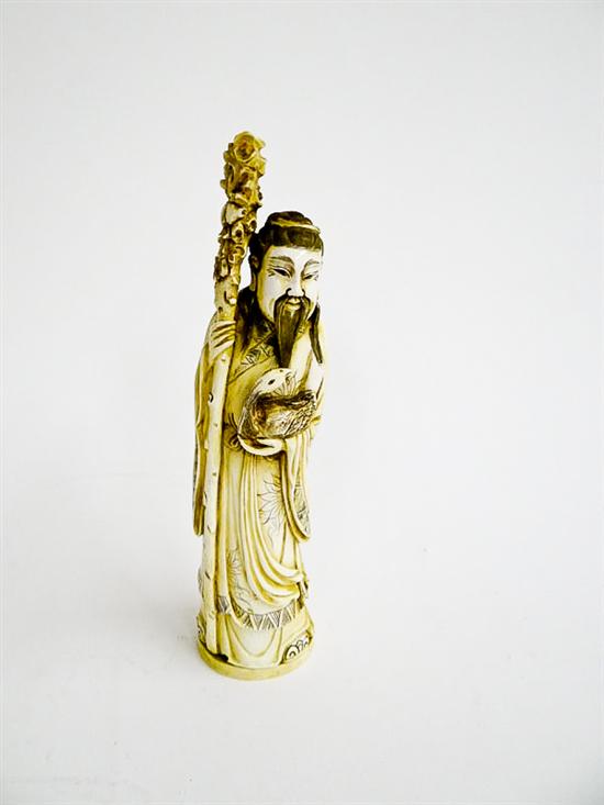 Appraisal: CARVED IVORY FIGURE China st half- th century Deity with