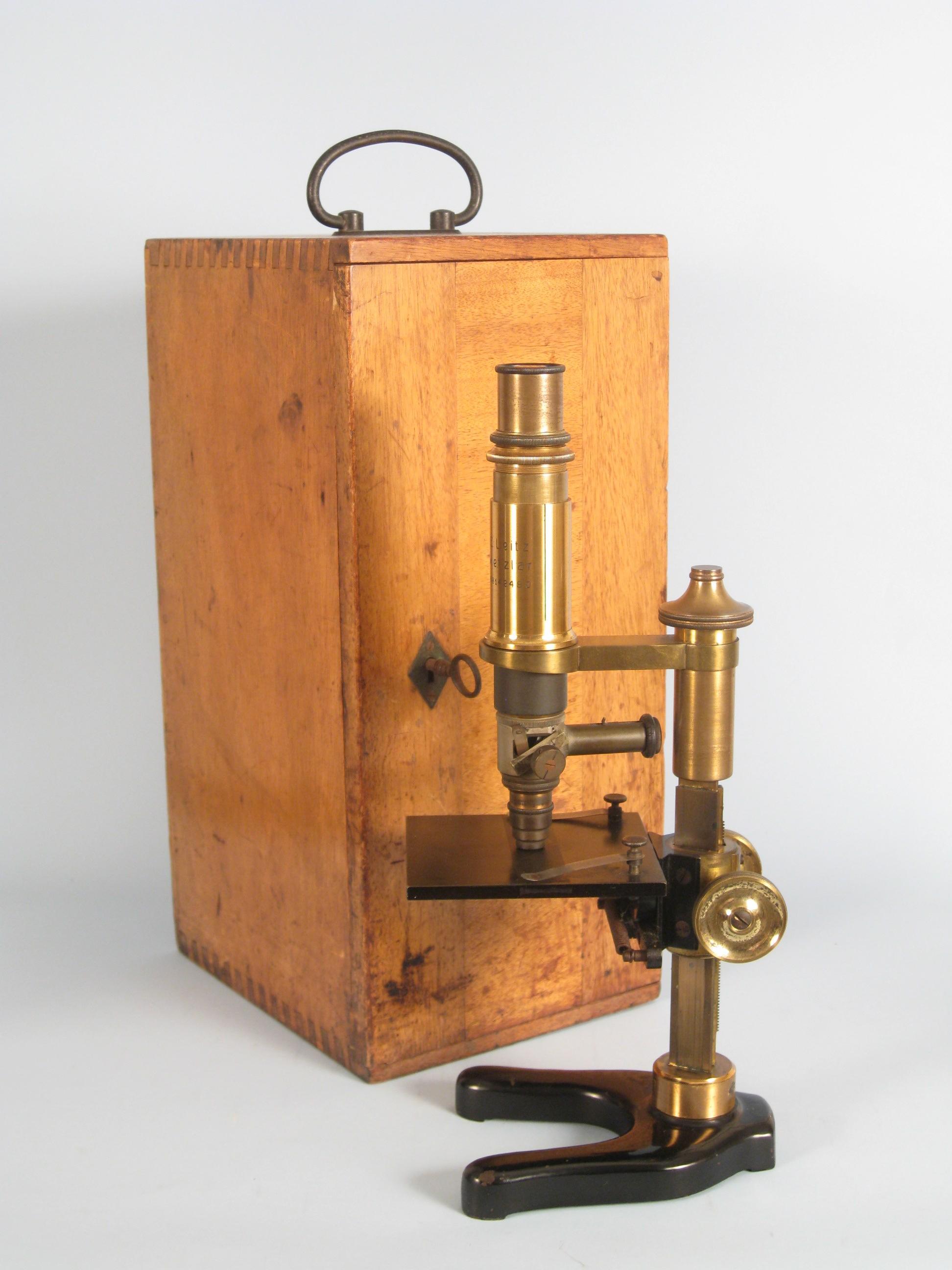 Appraisal: An E Leitz Weltzar brass Microscope and two Lenses in