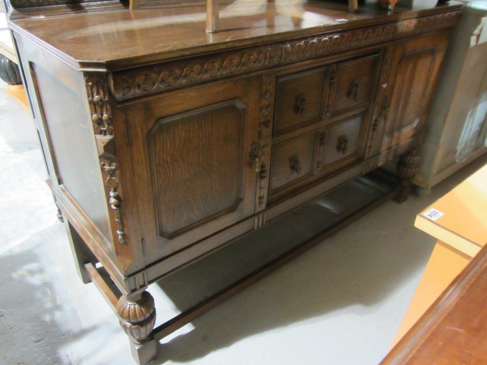 Appraisal: A th century reproduction carved oak sideboard