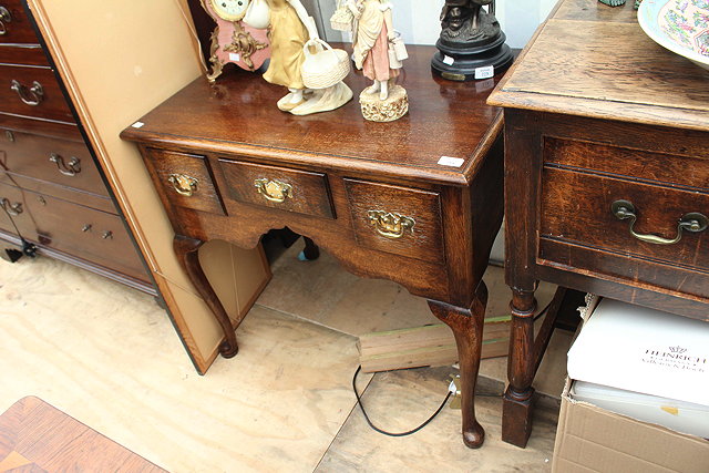 Appraisal: A GEORGIAN STYLE OAK LOW BOY with three drawers around