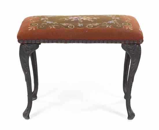 Appraisal: A Victorian Cast Iron Bench having a rectangular needlepoint upholstered