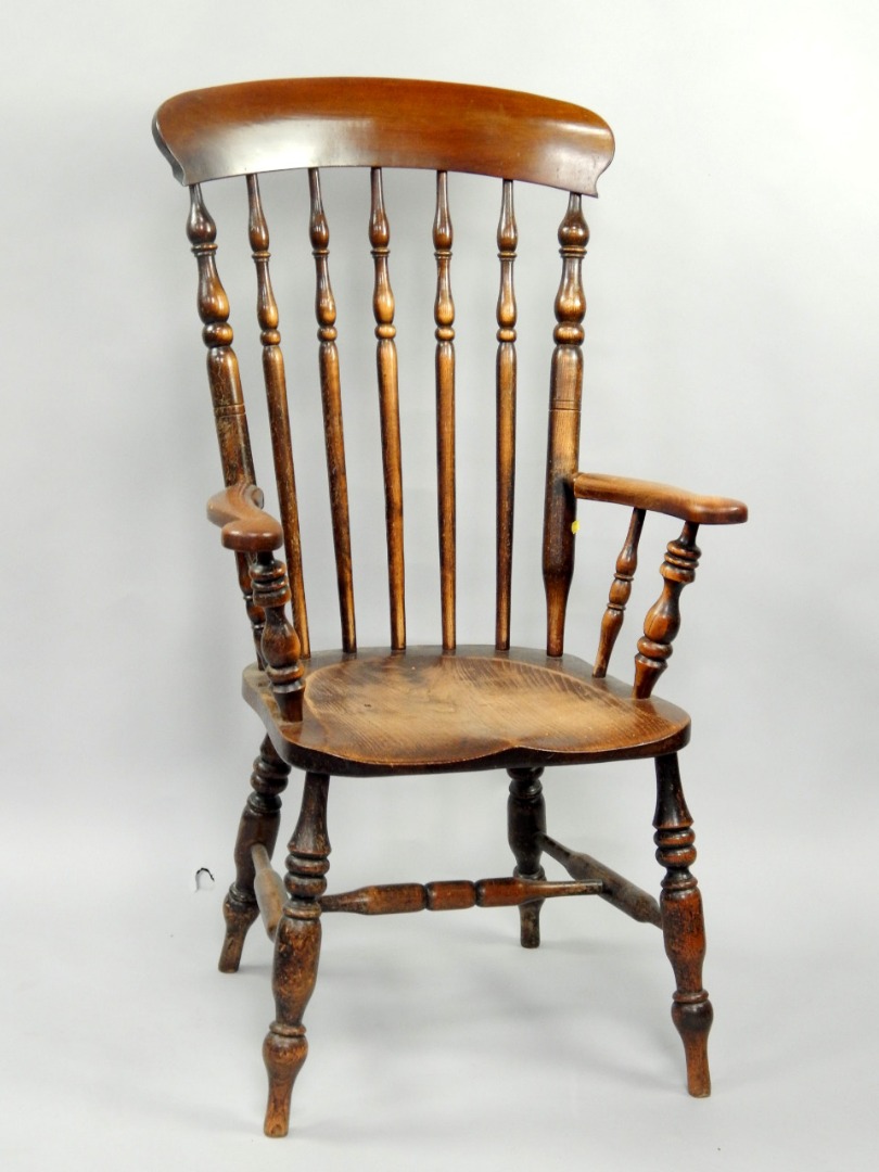 Appraisal: An elm and beech open armchair with high spindle back