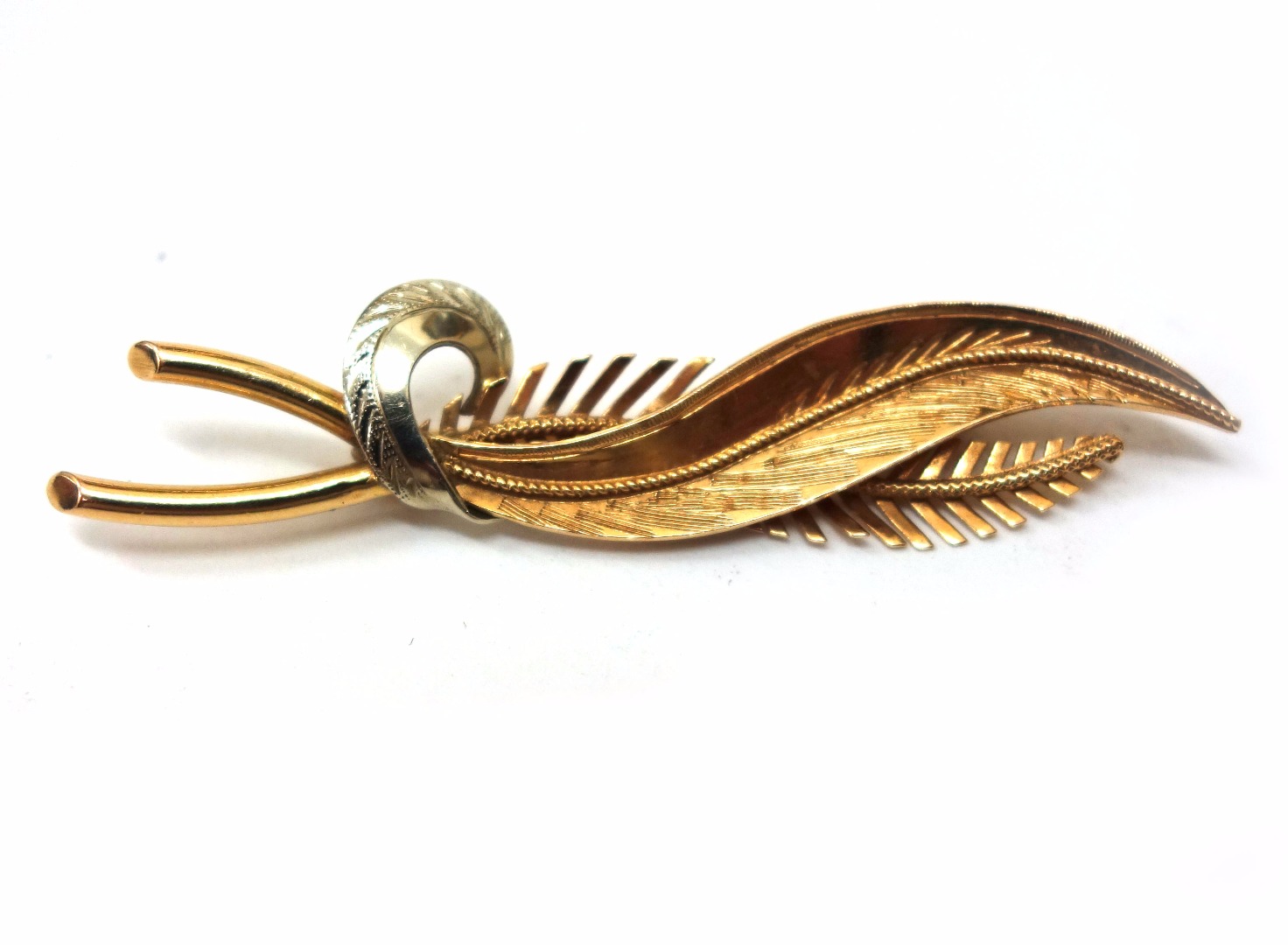 Appraisal: A modern bi-colour leaf spray brooch in the form of