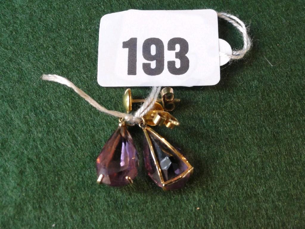 Appraisal: A pair of amethyst drop earrings with stylised mounts