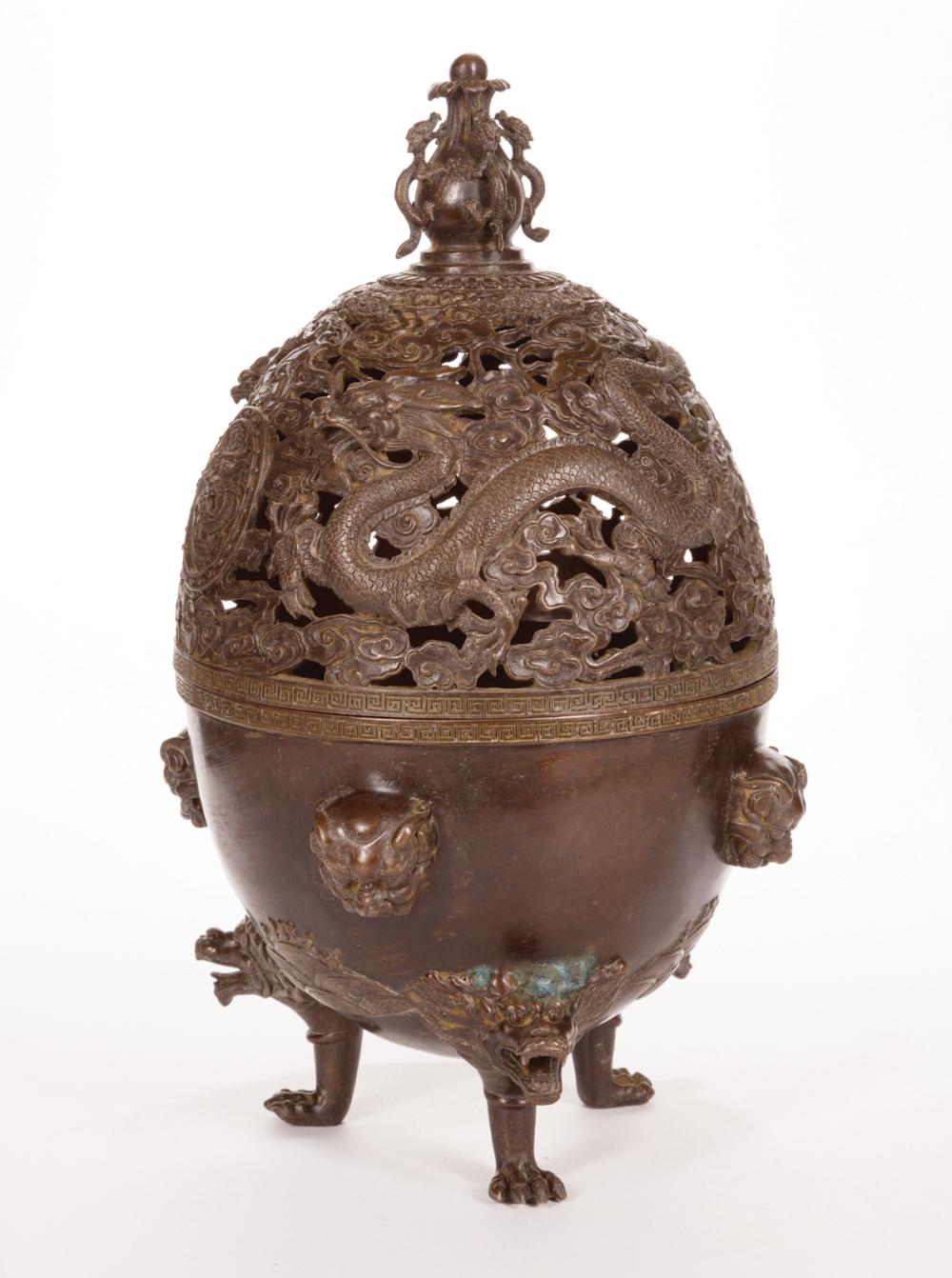 Appraisal: Chinese Bronze Covered Tripod Censer foliate finial with dragons cover