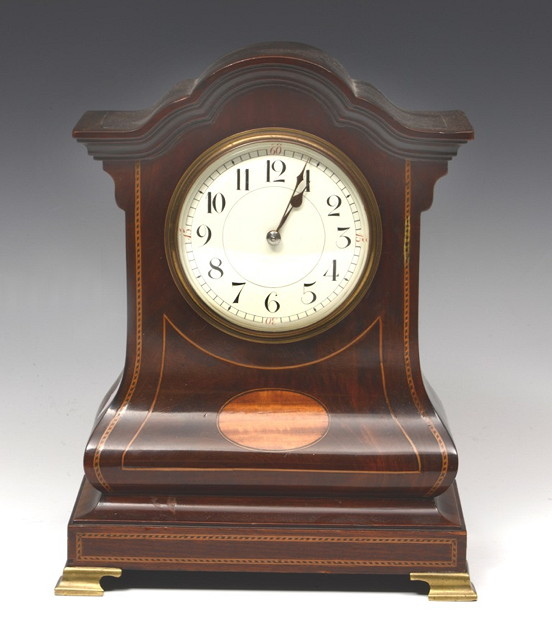 Appraisal: AN EDWARDIAN MAHOGANY MANTEL TIMEPIECE with circular white enamel dial