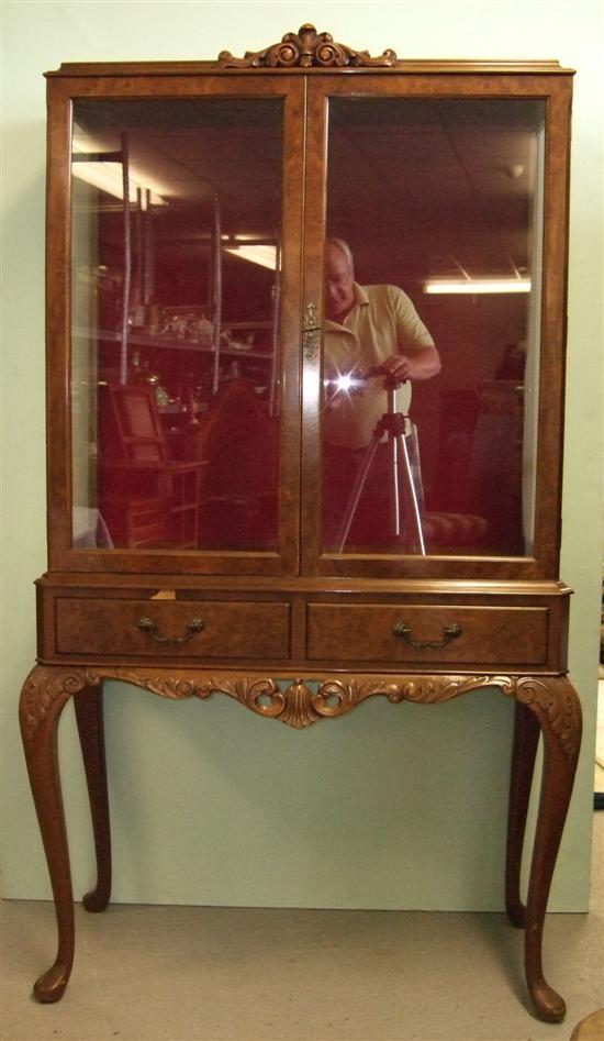 Appraisal: Pair of twentieth century walnut display cabinets with carved finials