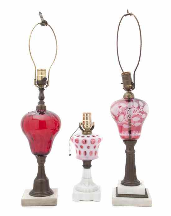 Appraisal: Three Cranberry Glass Lamps two having decoration and one opaque