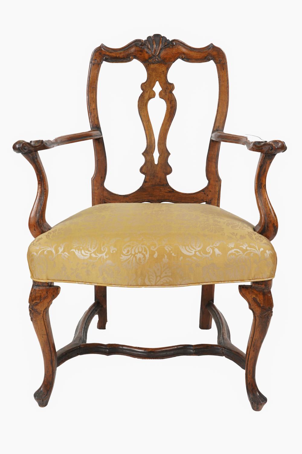 Appraisal: CONTINENTAL BAROQUE WALNUT ARMCHAIRwith gilt-patterned yellow fabric upholstery Condition refinished