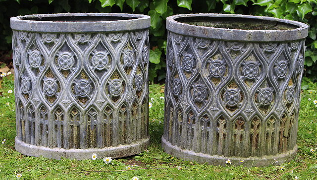 Appraisal: A PAIR OF FAUX LEAD CYLINDRICAL PLANTERS with Gothic decoration