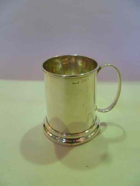 Appraisal: A SMALL SILVER MUG of plain tapering cylindrical form with