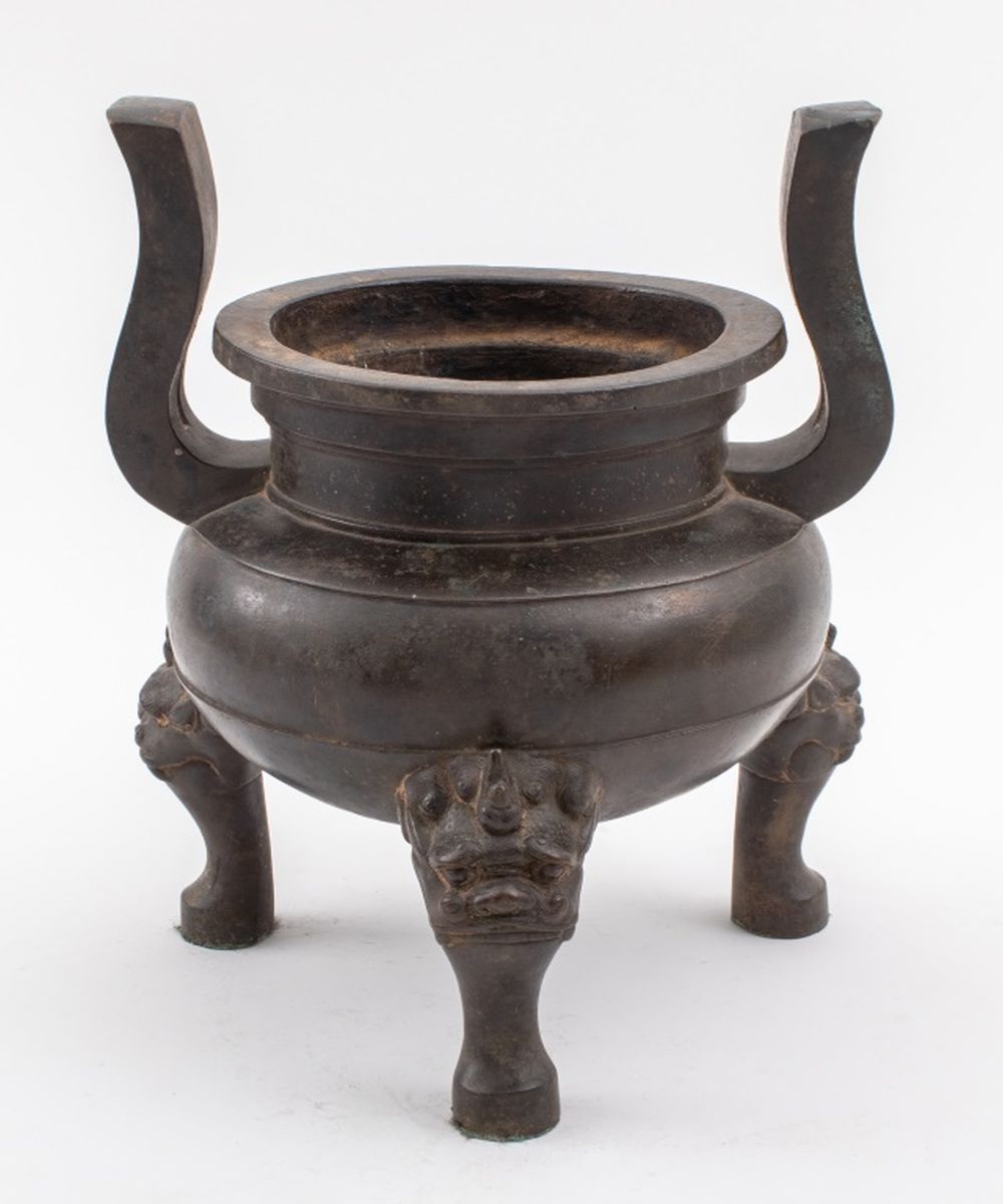 Appraisal: CHINESE PATINATED BRONZE TRIPOD CENSER W FOO LIONS Chinese heavily