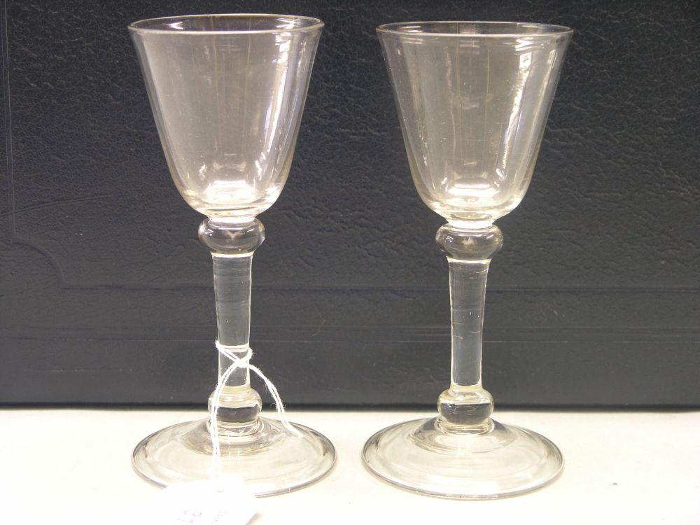 Appraisal: A pair of balustroid wine glasses round funnel bowls plain