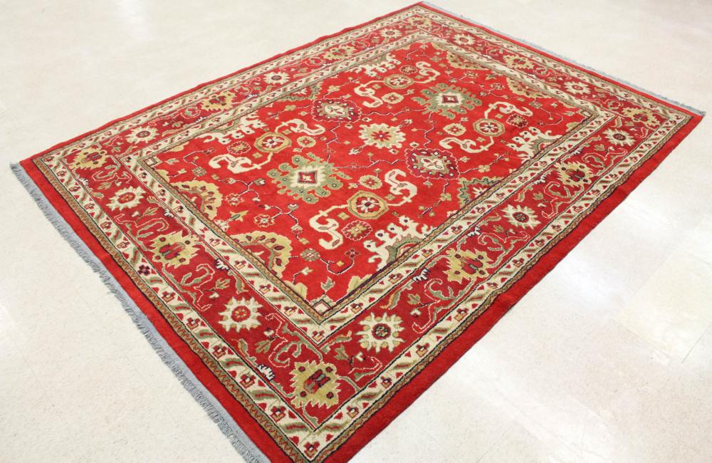 Appraisal: HAND KNOTTED ORIENTAL CARPET stylized floral design on red ground