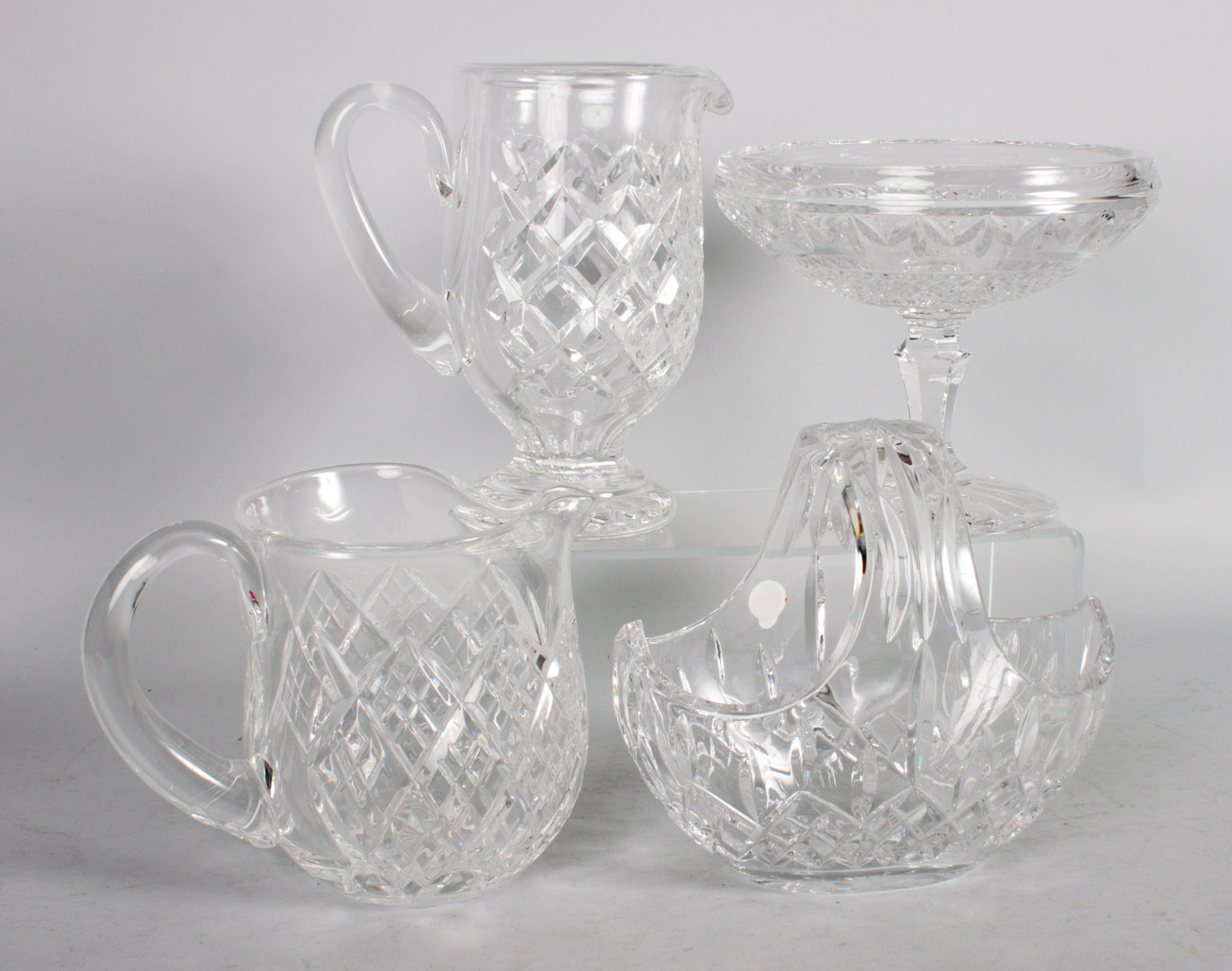 Appraisal: Four Waterford crystal table articles including pitcher footed pitcher bride's