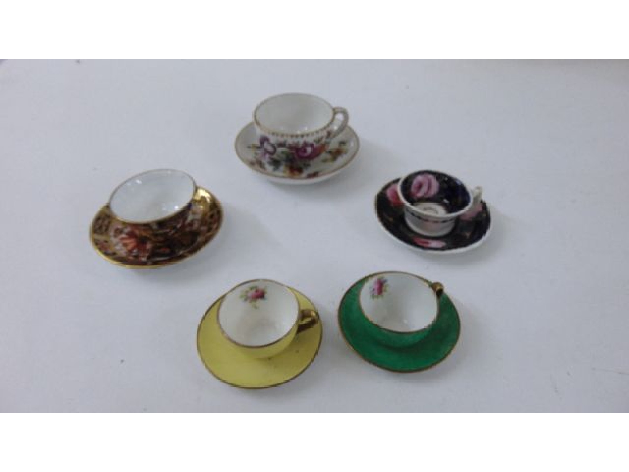 Appraisal: Five miniature porcelain cups and saucers Derby Crown Ware etc