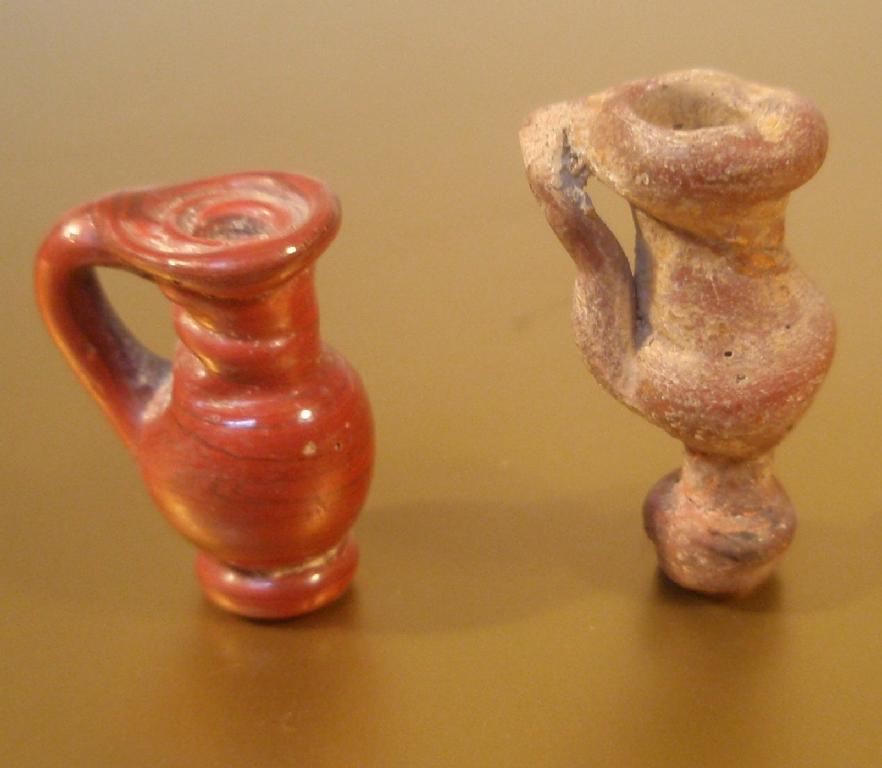 Appraisal: Two late Roman juglet pendants made in opaque red glass