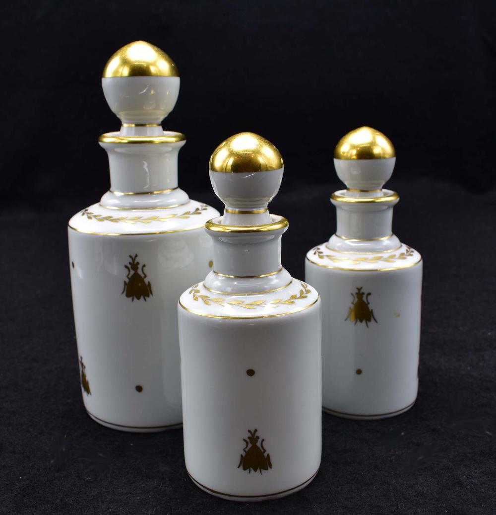 Appraisal: THREE LIMOGES PAINTED STOPPERED VANITY BOTTLESEach decorated with gilded bees