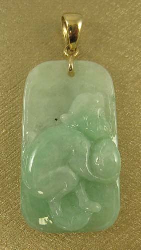 Appraisal: JADE AND FOURTEEN KARAT GOLD PENDANT the light green jade