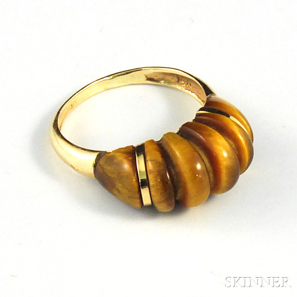 Appraisal: kt Gold and Carved Tiger's-eye Ring the gold band with