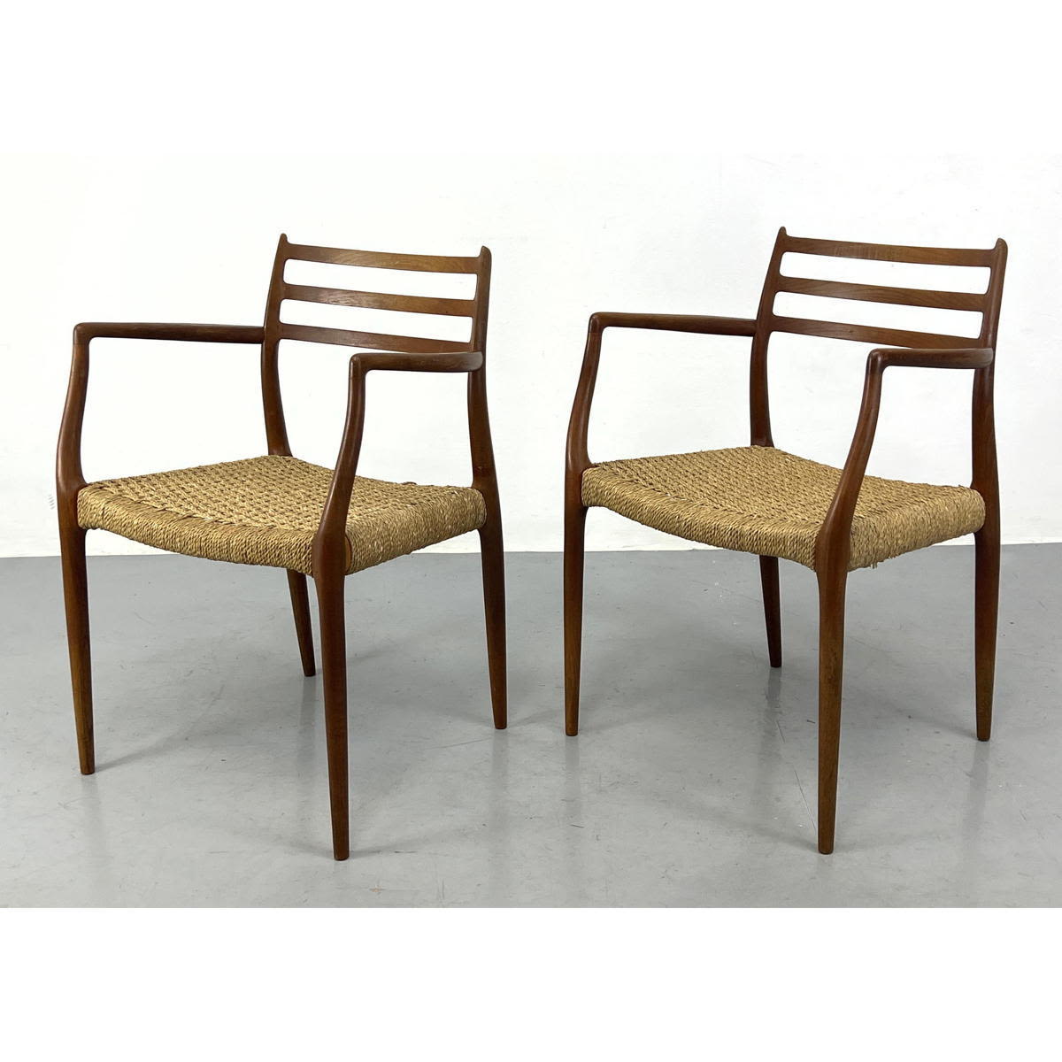 Appraisal: Pair of Niels Moller Teak Arm Chairs Dimensions H inches