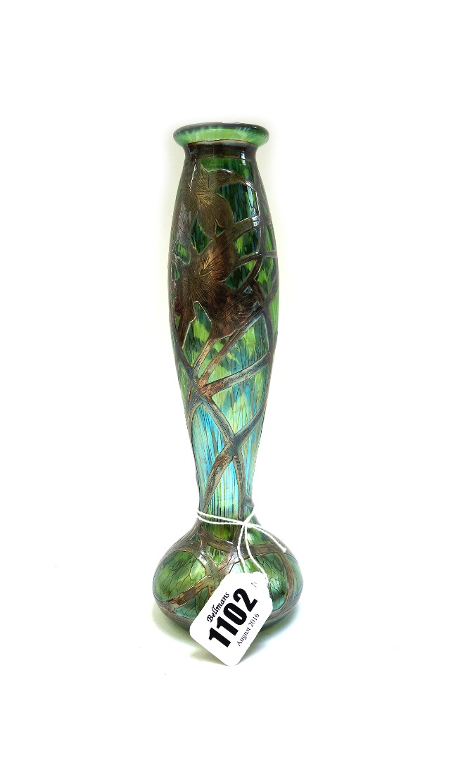 Appraisal: An iridescent green glass and silver overlaid vase probably Loetz