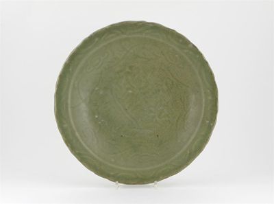 Appraisal: A celadon dish with a shaped rim and carved with