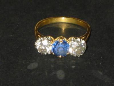 Appraisal: A SAPPHIRE AND DIAMOND THREE STONE RING comprising two brilliant