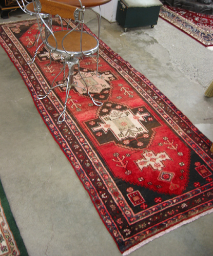 Appraisal: SEMI-ANTIQUE PERSIAN RUNNER Hamadan tribal the plain red field decorated