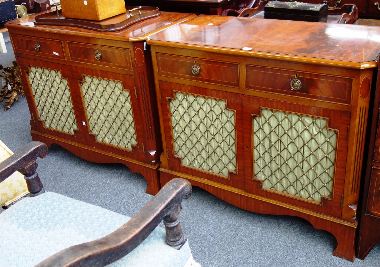 Appraisal: A pair of Regency style mahogany and crossbanded side cabinets