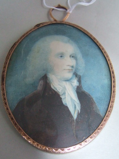 Appraisal: An oval portrait miniature of a gentleman wearing a brown