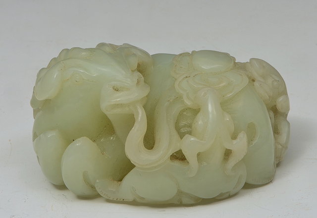 Appraisal: A CHINESE WHITE JADE BOULDER carved as a recumbent ox