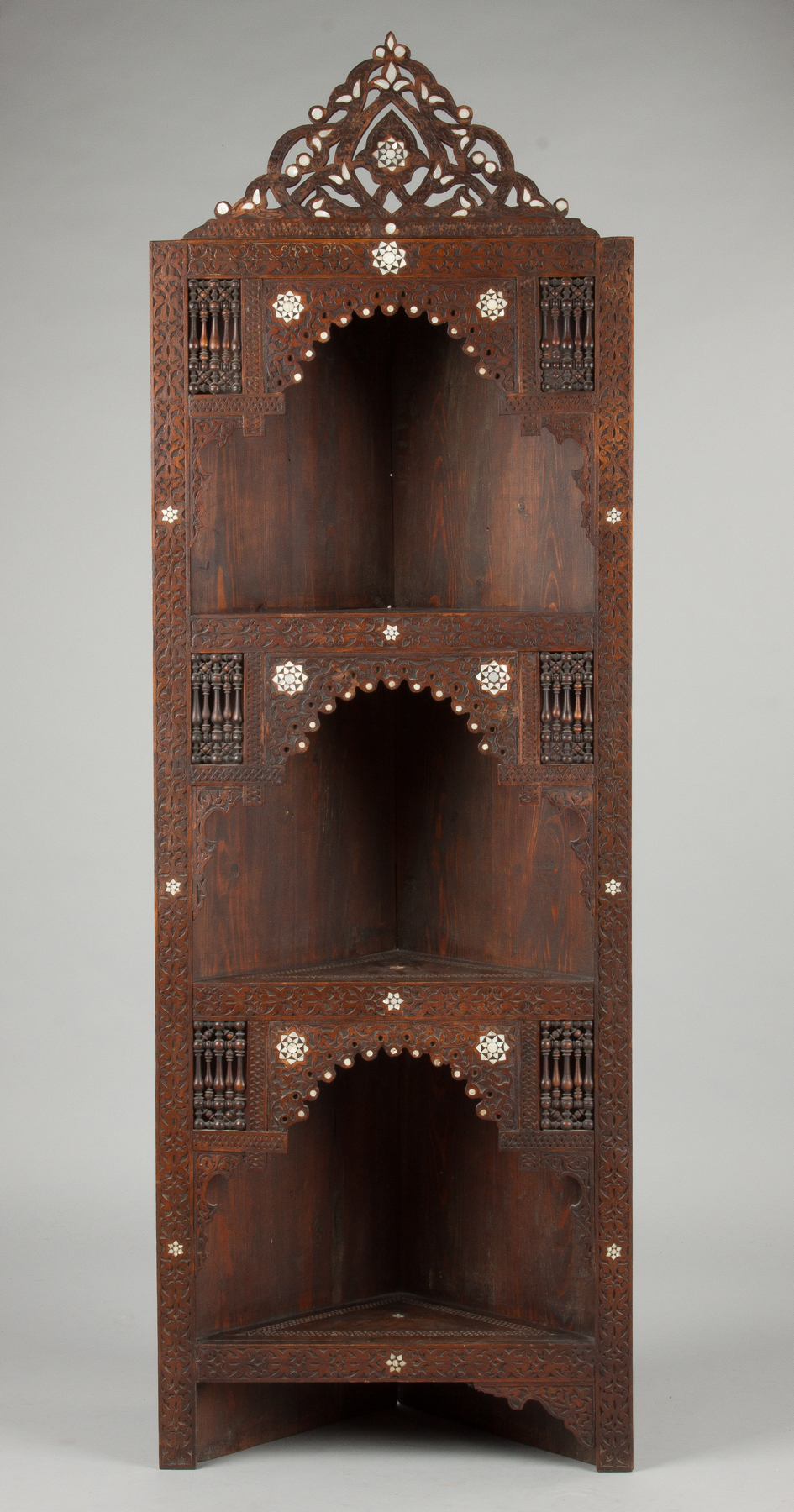 Appraisal: Middle Eastern Carved Corner Cabinet Late th cent With mother-of-pearl