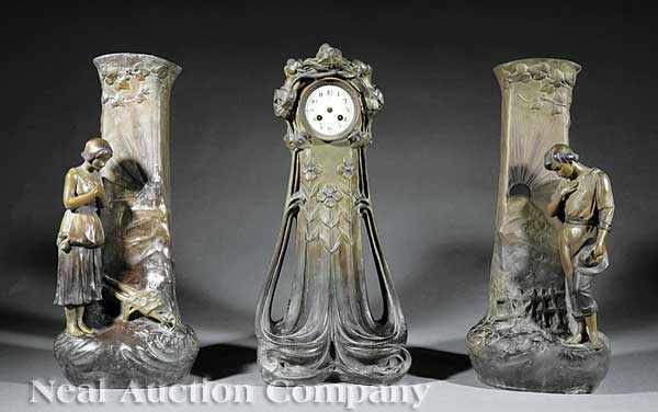 Appraisal: An Art Nouveau Patinated Metal Three Piece Clock Garniture c