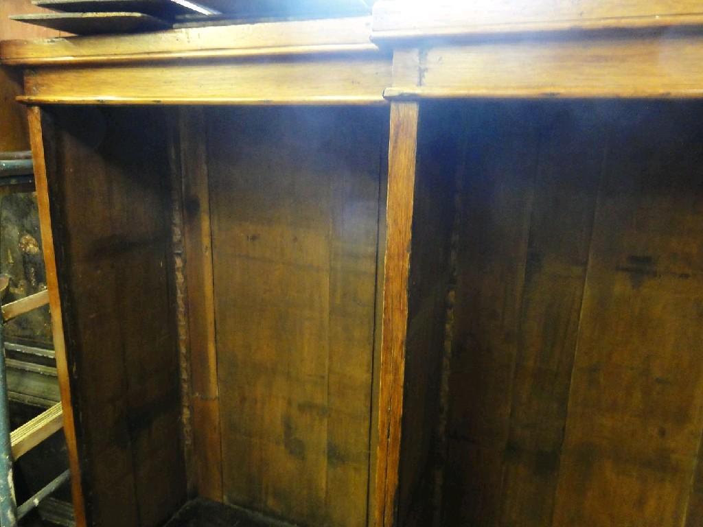 Appraisal: A th century oak breakfront open bookcase enclosing adjustable shelves