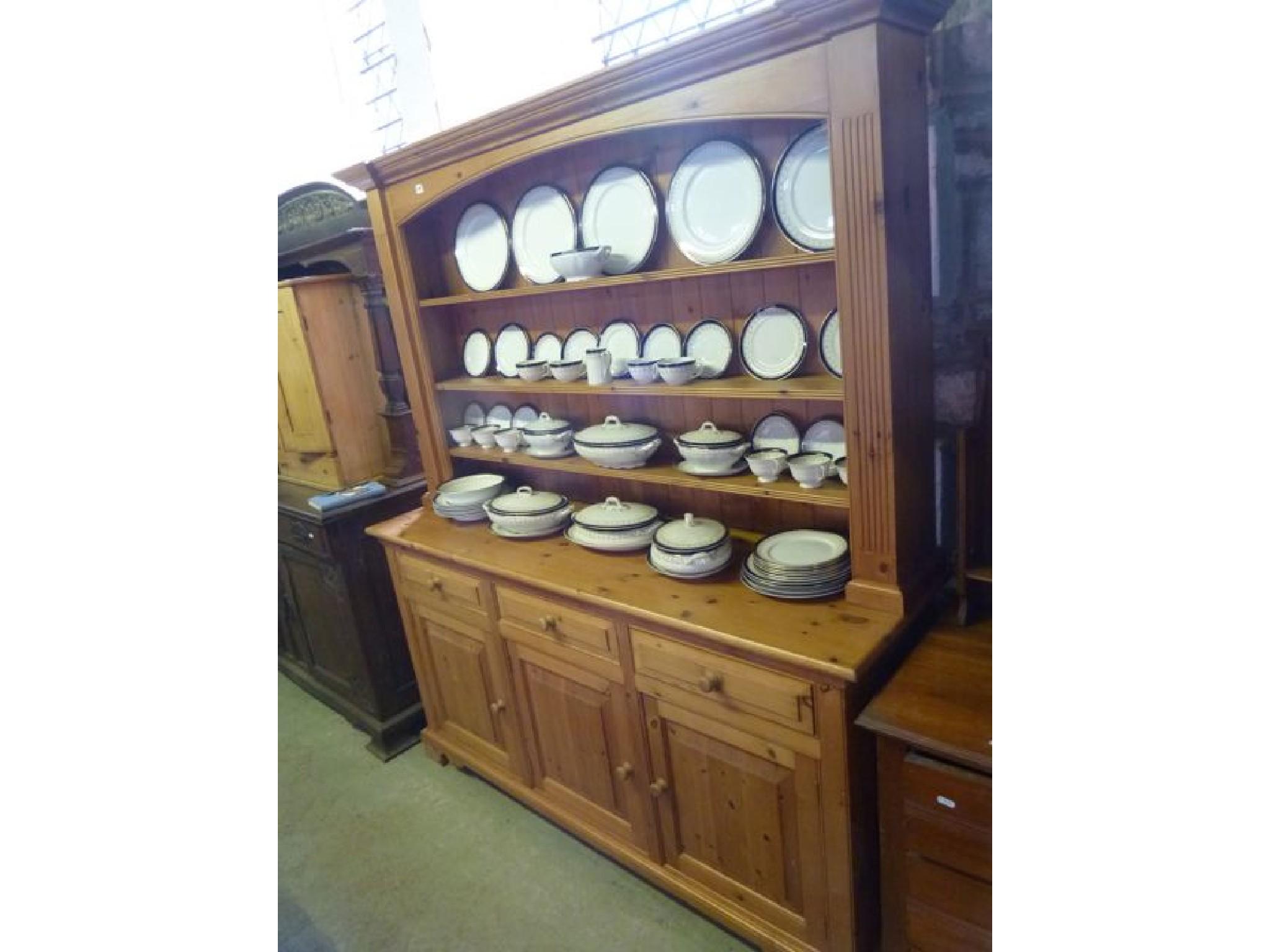 Appraisal: A contemporary stripped pine kitchen dresser with open plate rack