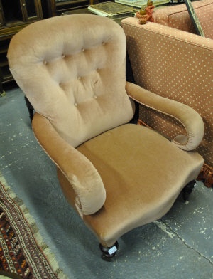 Appraisal: A Victorian open armchair with deep buttoned back and scroll