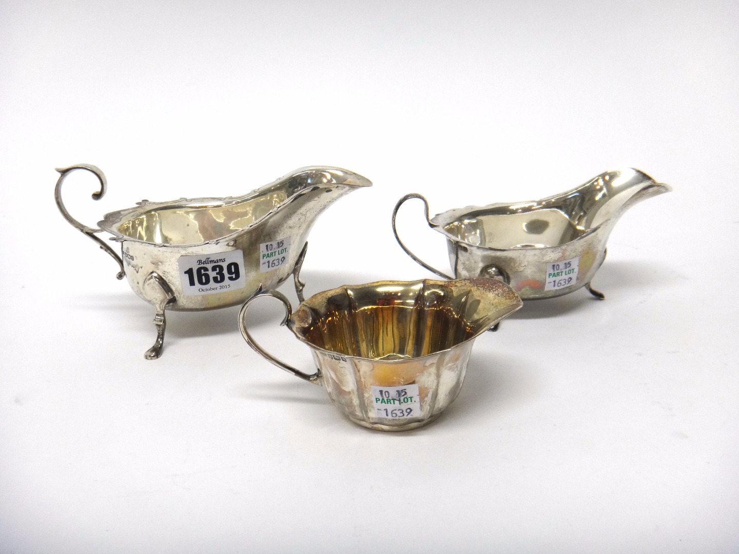 Appraisal: Silver comprising a sauceboat having a shaped rim scrolling handle