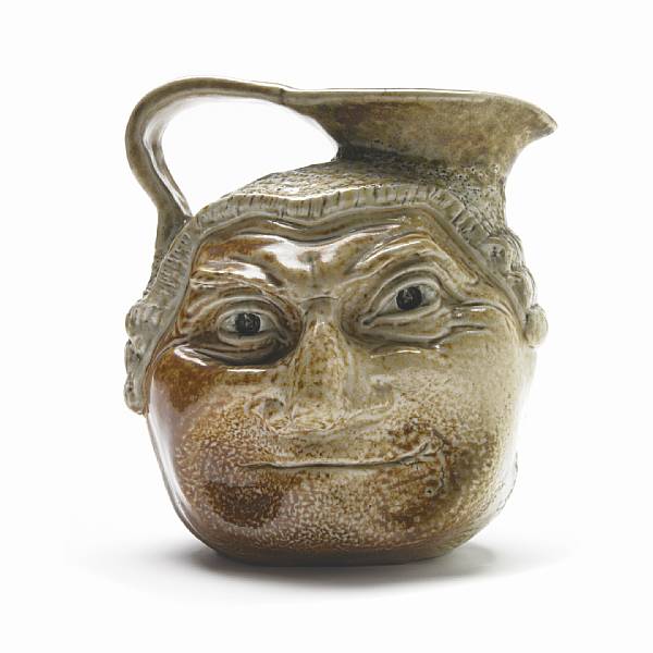 Appraisal: A Martin Brothers glazed stoneware two-sided Barrister face jug circa