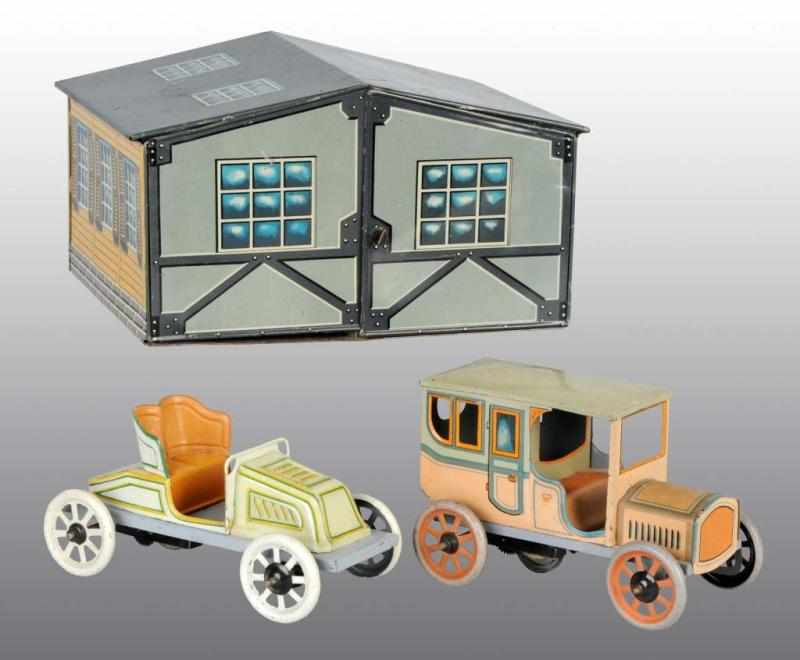 Appraisal: Tin Bing Garage Set with Two Wind-Up Automobiles Description German