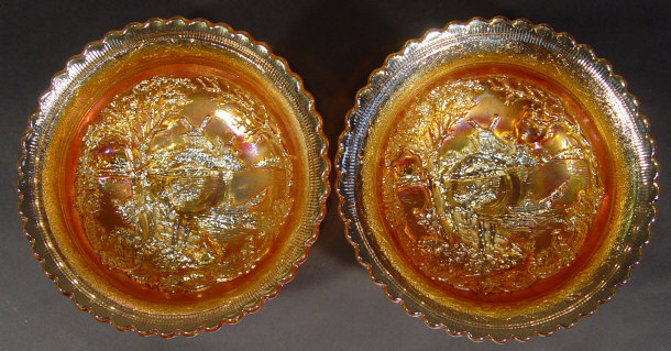 Appraisal: Pair of three-footed orange Carnival glass bowls moulded with riverside