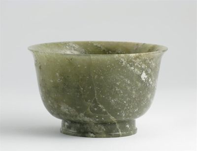 Appraisal: A Chinese mottled spinach jade bowl supported on a well