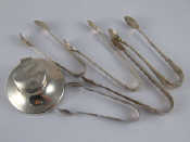 Appraisal: A small silver capstan inkwell four pairs silver tongs and