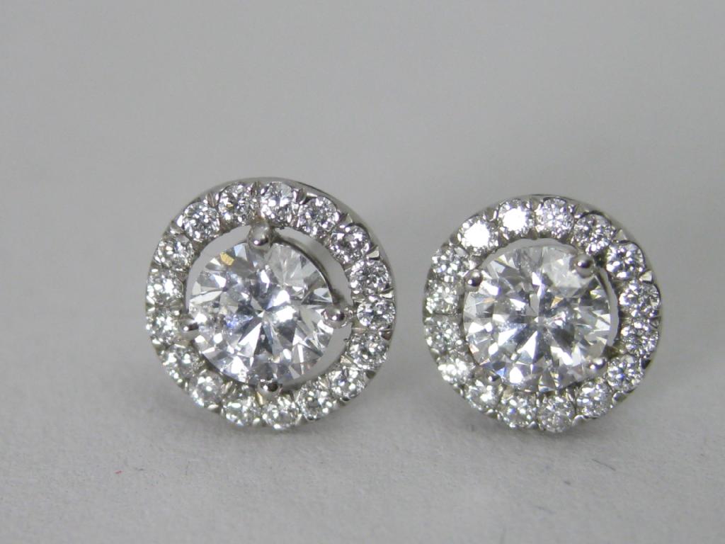 Appraisal: A pair of Diamond Ear Studs the central circular-cut stone