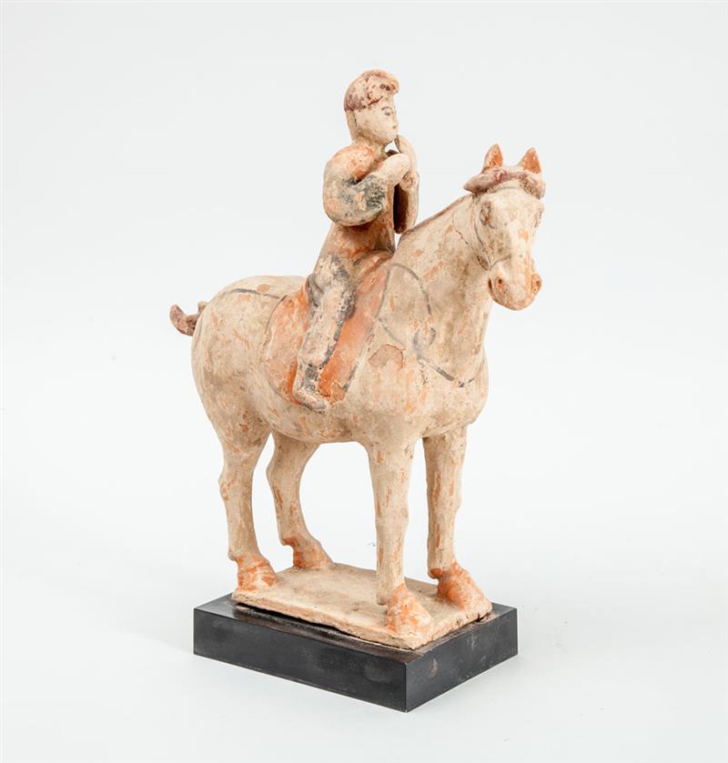 Appraisal: TANG STYLE UNGLAZED POTTERY EQUESTRIAN GROUP Modeled as a horse