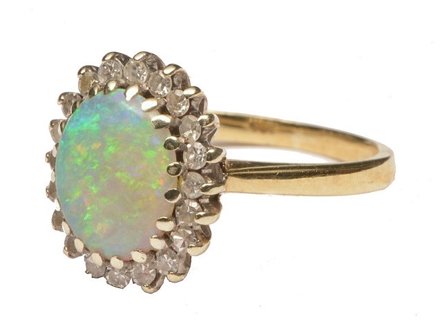 Appraisal: A CT GOLD RING with central opal surrounded by diamonds